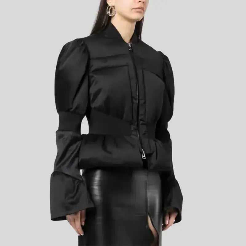 Parka femme chic en satin noir avec capuche discrète, manches volumineuses et taille ajustée