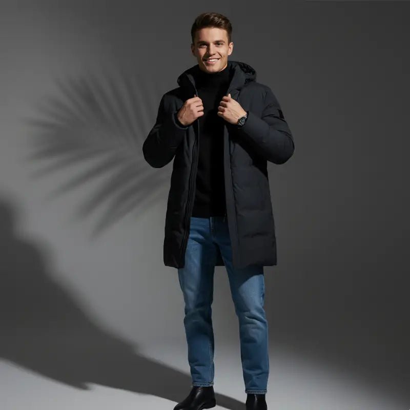 Homme portant une parka homme grande taille à capuche noire, style urbain, devant un fond minimaliste.